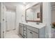 Bright bathroom featuring a double sink vanity with a framed mirror and tile flooring at 129 Doncaster Dr, Mooresville, NC 28115
