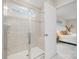 Modern bathroom with glass-enclosed shower and a glimpse into the stylish, light-filled main bedroom at 129 Doncaster Dr, Mooresville, NC 28115