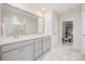 Elegant bathroom boasts a double vanity, large mirror, and access to a well-organized shoe closet at 129 Doncaster Dr, Mooresville, NC 28115