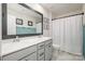 Bright bathroom featuring double sinks, a large mirror, and a shower with a curtain at 129 Doncaster Dr, Mooresville, NC 28115