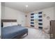Cozy bedroom with carpet, window, closet, and a blue bedspread at 129 Doncaster Dr, Mooresville, NC 28115