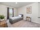 Neutral bedroom features a single bed, artwork, and a view to the outdoors at 129 Doncaster Dr, Mooresville, NC 28115