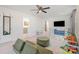 Versatile bonus room with cozy seating, playful decor, and easy access to adjacent rooms for flexible living at 129 Doncaster Dr, Mooresville, NC 28115
