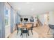 Open floor plan with dining and living area featuring ample natural light at 129 Doncaster Dr, Mooresville, NC 28115