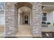 Stone entryway leading to the front door, with a bench, and landscaping around the porch at 129 Doncaster Dr, Mooresville, NC 28115