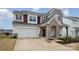 Beautiful two-story home featuring a two-car garage and a stone pillar porch at 129 Doncaster Dr, Mooresville, NC 28115