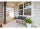 Cozy front porch with a bench, potted plants, and an outdoor rug, perfect for relaxing at 129 Doncaster Dr, Mooresville, NC 28115