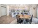 Open kitchen boasts gray cabinets, stainless appliances, and a wooden breakfast table at 129 Doncaster Dr, Mooresville, NC 28115