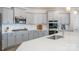 Modern kitchen with stainless steel appliances, gray cabinetry, and a spacious countertop at 129 Doncaster Dr, Mooresville, NC 28115