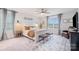 Bright main bedroom with plush rug, decorative pillows, ceiling fan, and natural light, offering comfort and style at 129 Doncaster Dr, Mooresville, NC 28115