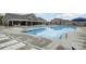Community pool with lounge chairs and clubhouse in a well-maintained neighborhood setting on a partly cloudy day at 129 Doncaster Dr, Mooresville, NC 28115