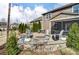 Inviting backyard with a stone fire pit, patio furniture, string lights, and well-maintained landscaping at 13240 Carolina Wren Ct, Charlotte, NC 28278