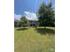 Expansive backyard featuring a lush green lawn and a charming screened-in porch at 13240 Carolina Wren Ct, Charlotte, NC 28278