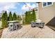 Relaxing backyard featuring an outdoor table, grill, bar with stools, and a nicely paved patio at 13240 Carolina Wren Ct, Charlotte, NC 28278