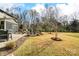 Expansive backyard featuring a stone fire pit, patio, landscaping, and plenty of space for activities at 13240 Carolina Wren Ct, Charlotte, NC 28278