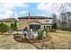 Landscaped backyard features a stone firepit and ample seating space at 13240 Carolina Wren Ct, Charlotte, NC 28278