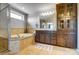 Bathroom features a soaking tub and granite counter with storage at 13240 Carolina Wren Ct, Charlotte, NC 28278