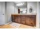 Bathroom features a granite countertop with dark cabinets, mirror and vanity lights at 13240 Carolina Wren Ct, Charlotte, NC 28278