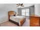 Cozy bedroom features a ceiling fan and natural light from the large window at 13240 Carolina Wren Ct, Charlotte, NC 28278