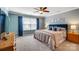 Spacious bedroom showcasing soft blue walls, large window and plush bedding at 13240 Carolina Wren Ct, Charlotte, NC 28278