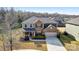 Beautiful two-story brick home with a manicured front yard, mature trees, and attached two car garage at 13240 Carolina Wren Ct, Charlotte, NC 28278