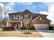 Charming two-story brick home with landscaped front yard and attached two-car garage at 13240 Carolina Wren Ct, Charlotte, NC 28278