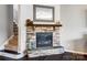 Beautiful stone fireplace with wooden mantle, decorative accents, and a cozy ambiance near the staircase at 13240 Carolina Wren Ct, Charlotte, NC 28278