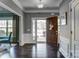 Elegant foyer with dark wood floors, white trim, and a view to the front door at 13240 Carolina Wren Ct, Charlotte, NC 28278