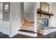 Inviting hallway with the stone fireplace mantel and carpeted stairs at 13240 Carolina Wren Ct, Charlotte, NC 28278