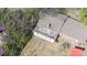 Aerial view of the backyard with brickwork, garden, and greenhouse, surrounded by lush greenery at 143 Reid St, Rock Hill, SC 29730