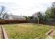 Large backyard with grass, raised garden beds, brick accents, and perimeter fencing at 143 Reid St, Rock Hill, SC 29730