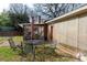 Cozy backyard with outdoor seating area, red brick accents, and mature trees at 143 Reid St, Rock Hill, SC 29730