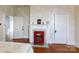 Bedroom featuring hardwood floors, a decorative fireplace, and multiple entry doors at 143 Reid St, Rock Hill, SC 29730