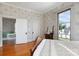 Charming bedroom with hardwood floors, vintage wallpaper, and a view to the outside at 143 Reid St, Rock Hill, SC 29730