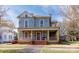 Charming two-story home with a welcoming front porch and detailed architectural features in a residential neighborhood at 143 Reid St, Rock Hill, SC 29730