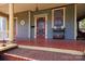 Charming front porch with detailed columns, red-painted flooring, and decorative touches for an inviting entrance at 143 Reid St, Rock Hill, SC 29730