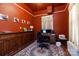 Dedicated office featuring dark walls, vintage cabinet, and decorative rug creating a productive workspace at 143 Reid St, Rock Hill, SC 29730