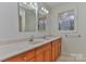Bathroom featuring a double sink vanity, large mirrors, and a window for natural light at 1630 26Th Ne St, Hickory, NC 28601