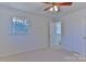 Bedroom with neutral carpet, white walls, ceiling fan, and view to bathroom at 1630 26Th Ne St, Hickory, NC 28601