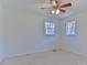 Bedroom with neutral carpet, white walls, ceiling fan, and view of the outdoors at 1630 26Th Ne St, Hickory, NC 28601