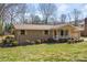 Quaint brick home featuring a cozy porch and well-manicured lawn with mature landscaping and inviting curb appeal at 1630 26Th Ne St, Hickory, NC 28601