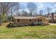 Quaint brick home featuring a cozy porch and well-manicured lawn with mature landscaping and inviting curb appeal at 1630 26Th Ne St, Hickory, NC 28601