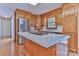 Well-lit kitchen featuring tile countertops, stainless steel appliances, and hardwood floors at 1630 26Th Ne St, Hickory, NC 28601