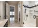 Elegant bathroom boasts dual shower heads, white marble, a glass enclosure, and seamless access to a bedroom at 1891 Felts Pkwy, Fort Mill, SC 29715