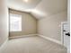 This bedroom has neutral colored walls, carpet, a window, and white trim at 1891 Felts Pkwy, Fort Mill, SC 29715