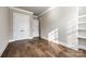 This bedroom features hardwood floors, white trim, neutral colored walls, and double closets at 1891 Felts Pkwy, Fort Mill, SC 29715