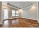 Bright bedroom features a tray ceiling, recessed lights, and a door to the outside, blending comfort and convenience at 1891 Felts Pkwy, Fort Mill, SC 29715