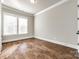 This bedroom has two windows, hardwood floors, white trim, and neutral colored walls at 1891 Felts Pkwy, Fort Mill, SC 29715