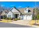 Charming two-story home with a well-maintained lawn, manicured landscaping, and a two-car garage on a sunny day at 1891 Felts Pkwy, Fort Mill, SC 29715
