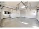 Spacious and well-lit two-car garage with epoxy flooring, storage shelves, and a clean, organized layout at 1891 Felts Pkwy, Fort Mill, SC 29715